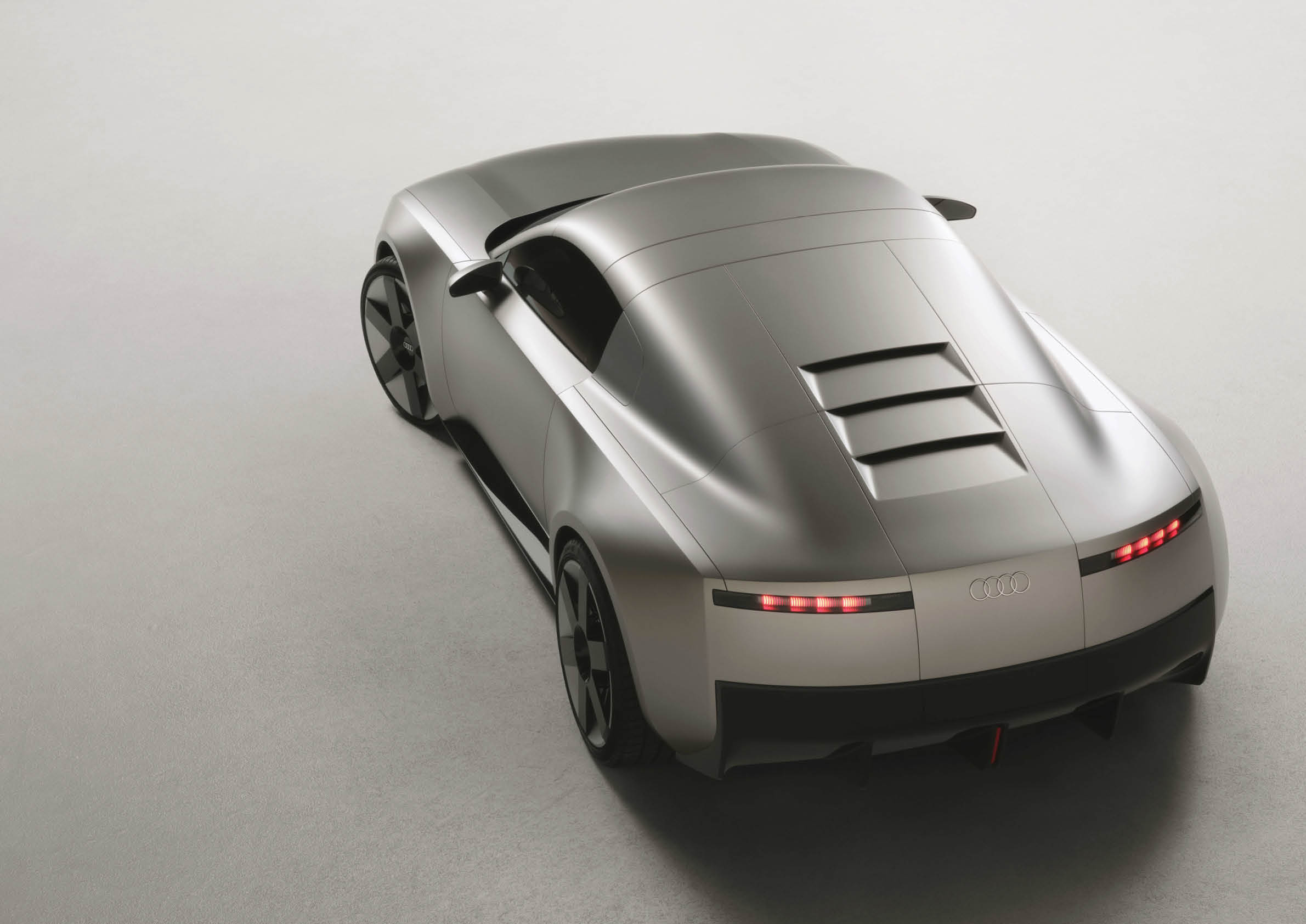 Static studio shot, exterior, rear three-quarter view, top-down perspective